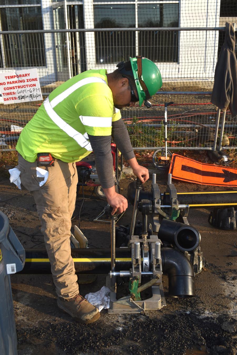 Burns Construction operator running a pipe fusion machine on a job site