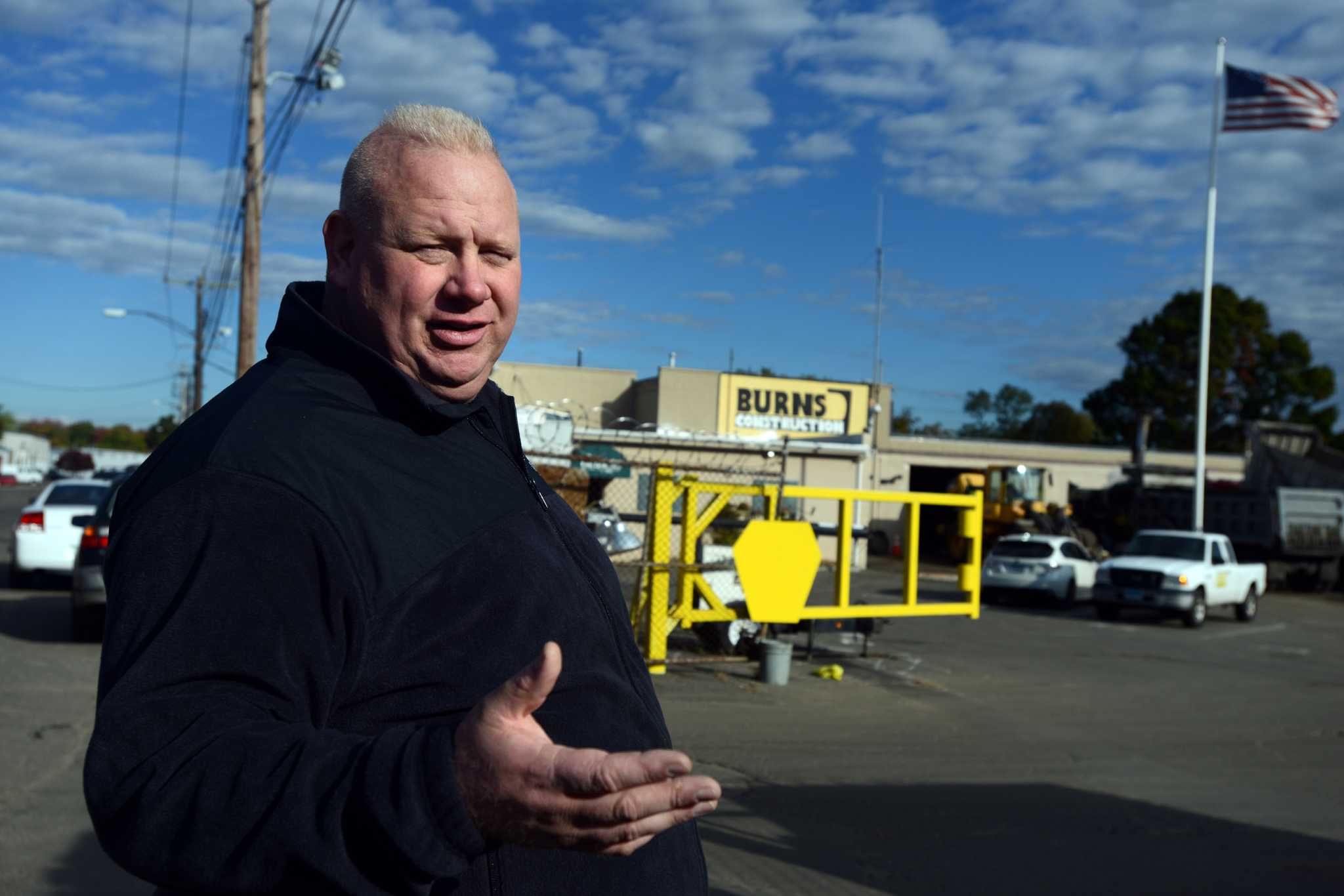 Portrait of a Burns Construction team member standing outside the company office
