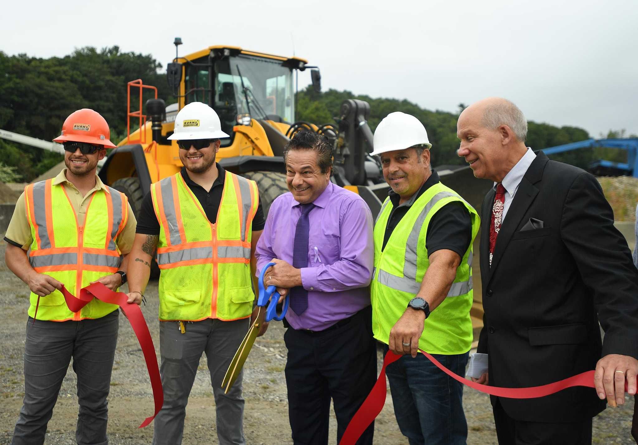 Burns Construction employees and leadership celebrating at a ribbon-cutting ceremony