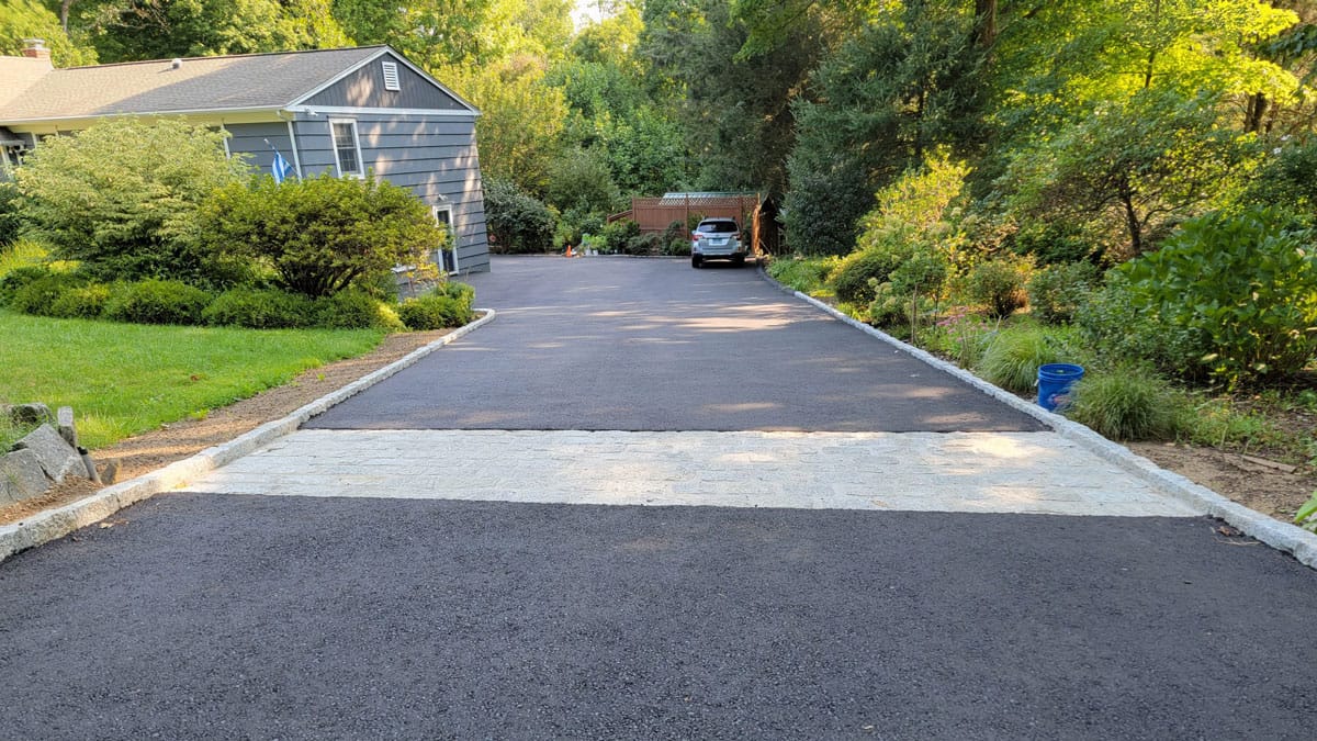 Finished driveway with a decorative cobblestone border